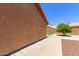 Wide backyard showing a small tree, concrete walkway and low block fence at 408 W Stacey Ln, Tempe, AZ 85284