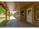 Covered patio boasts views of the grassy backyard and block fence for privacy at 408 W Stacey Ln, Tempe, AZ 85284