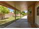 Covered patio overlooks a well-maintained backyard and block fence for privacy at 408 W Stacey Ln, Tempe, AZ 85284