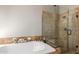 Beautiful bathroom with a soaking tub with tile surround and a glass enclosed shower at 408 W Stacey Ln, Tempe, AZ 85284