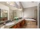 Main bathroom with granite counters, dual sinks, soaking tub and glass enclosed shower at 408 W Stacey Ln, Tempe, AZ 85284