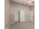 Bedroom with neutral walls and carpet featuring closet with white sliding doors at 408 W Stacey Ln, Tempe, AZ 85284