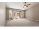 Bright bedroom with neutral carpeting and sliding door access to backyard at 408 W Stacey Ln, Tempe, AZ 85284