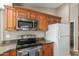 Close-up of a kitchen featuring stainless steel appliances and wooden cabinetry at 408 W Stacey Ln, Tempe, AZ 85284