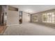 Bright living room features neutral walls, carpet, plantation shutters and chandelier at 408 W Stacey Ln, Tempe, AZ 85284