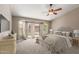 Calm main bedroom with a ceiling fan, carpet, and sliding glass doors to the backyard at 408 W Stacey Ln, Tempe, AZ 85284