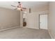 Spacious main bedroom with a ceiling fan, carpet flooring and an ensuite bathroom with a soaking tub at 408 W Stacey Ln, Tempe, AZ 85284