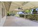 Spacious covered back patio with ceiling fans, leading to lush backyard at 4212 W Tierra Buena Ln, Phoenix, AZ 85053