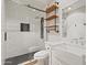 Modern bathroom featuring a walk-in shower with black hardware, wood shelving and a stylish white vanity at 4212 W Tierra Buena Ln, Phoenix, AZ 85053
