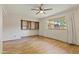 Bright bedroom features wood-look tile flooring and closet with built-in storage at 4212 W Tierra Buena Ln, Phoenix, AZ 85053