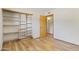 Bedroom with built-in closet shelving and wood look tile throughout at 4212 W Tierra Buena Ln, Phoenix, AZ 85053