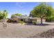 Inviting single-story home with desert landscaping, a large tree and a spacious three-car garage at 4212 W Tierra Buena Ln, Phoenix, AZ 85053