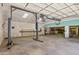 Spacious garage interior with a car lift, storage shelves, and ample workspace at 4212 W Tierra Buena Ln, Phoenix, AZ 85053