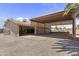 Open garage with car lift and overhead storage, offering ample space for vehicles and equipment at 4212 W Tierra Buena Ln, Phoenix, AZ 85053