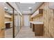 Large laundry room with cabinets, countertops, mirrored sliding closet, and tile flooring at 4212 W Tierra Buena Ln, Phoenix, AZ 85053
