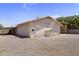 Exterior view of a versatile outbuilding with a greenhouse addition on a gravel lot at 4212 W Tierra Buena Ln, Phoenix, AZ 85053