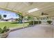 Covered patio overlooking the expansive backyard featuring a playground and lush greenery at 4212 W Tierra Buena Ln, Phoenix, AZ 85053