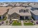 Aerial view of a home with stone accents, dormer windows, manicured landscaping, and a well-kept lawn at 4302 E Cynthia St, Gilbert, AZ 85295