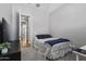 Neutral bedroom showcasing plush carpeting and light walls with a TV and bed at 4302 E Cynthia St, Gilbert, AZ 85295