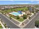Aerial view of a community pool with palm trees, sun shades, and ample parking at 4302 E Cynthia St, Gilbert, AZ 85295
