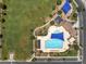 Overhead view of community pool with sunshades, chairs, and well-kept landscaping in a residential area at 4302 E Cynthia St, Gilbert, AZ 85295