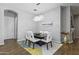 Chic dining room featuring a modern chandelier, contemporary art, and seating for six guests at 4302 E Cynthia St, Gilbert, AZ 85295
