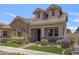 Charming home with stone accents, a covered porch, manicured landscaping, and a well-kept lawn at 4302 E Cynthia St, Gilbert, AZ 85295