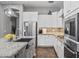 This is a kitchen with stainless steel appliances, white cabinets, and granite countertops at 4302 E Cynthia St, Gilbert, AZ 85295