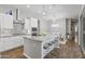 Modern kitchen boasts an island with bar seating, stainless steel appliances, and stylish pendant lighting at 4302 E Cynthia St, Gilbert, AZ 85295