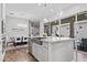 Bright kitchen with island seating, stainless steel sink, and sliding glass doors to the outdoor patio at 4302 E Cynthia St, Gilbert, AZ 85295