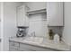 A well-appointed laundry room with ample counter space and storage at 4302 E Cynthia St, Gilbert, AZ 85295