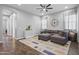 Cozy living room with hardwood floors, a stylish sectional sofa, and a neutral color palette at 4302 E Cynthia St, Gilbert, AZ 85295