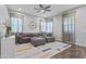 A cozy living room with a comfortable sectional, clock, and bright rug at 4302 E Cynthia St, Gilbert, AZ 85295