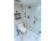Modern bathroom with white tiled walls, walk-in shower, black hardware, and floating shelves at 4303 E Cactus Rd # 128, Phoenix, AZ 85032