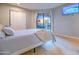 Bright bedroom featuring a sliding glass door, light-colored walls, and wood flooring at 4303 E Cactus Rd # 128, Phoenix, AZ 85032