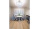Bright breakfast nook features a round table, gray chairs, white shutters, and a contemporary light fixture at 4303 E Cactus Rd # 128, Phoenix, AZ 85032