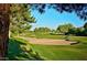 Scenic golf course view with sand traps, trees, and well-maintained green. Clear sky at 4303 E Cactus Rd # 128, Phoenix, AZ 85032
