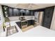 Updated kitchen features stainless steel appliances, white countertops, gold hardware, and dark cabinets at 4303 E Cactus Rd # 128, Phoenix, AZ 85032