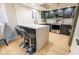Modern kitchen featuring quartz countertops, stainless steel appliances, and dark cabinets at 4303 E Cactus Rd # 128, Phoenix, AZ 85032