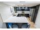 Modern kitchen featuring sleek black cabinetry, stainless steel appliances, and a bright white quartz countertop at 4303 E Cactus Rd # 128, Phoenix, AZ 85032