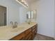 Bathroom with dual sinks, large mirrors, and vanity lights. Standing shower in view at 522 W Dennis Ct, Tempe, AZ 85283
