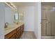 Dual sink bathroom featuring a large mirror, vanity lighting, and a standing shower at 522 W Dennis Ct, Tempe, AZ 85283