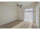 Bright bedroom featuring a ceiling fan, sliding glass door, and neutral carpet at 522 W Dennis Ct, Tempe, AZ 85283