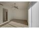 Bedroom with a ceiling fan, light neutral carpet, and sliding glass doors to a private patio at 522 W Dennis Ct, Tempe, AZ 85283