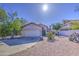 Inviting single-story home featuring a two-car garage, desert landscaping and a red tile roof at 522 W Dennis Ct, Tempe, AZ 85283