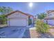 Attractive single-story home featuring desert landscaping, a red tile roof and two car garage at 522 W Dennis Ct, Tempe, AZ 85283