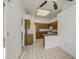 The kitchen features tile flooring, wooden cabinets, and white appliances at 522 W Dennis Ct, Tempe, AZ 85283