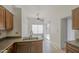 Open kitchen with tile floors, wood cabinets, and stainless steel sink at 522 W Dennis Ct, Tempe, AZ 85283