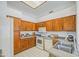 Bright kitchen featuring wood cabinetry, white appliances, and neutral countertops at 522 W Dennis Ct, Tempe, AZ 85283