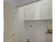 A simple laundry room featuring white cabinets and essential utility connections at 522 W Dennis Ct, Tempe, AZ 85283